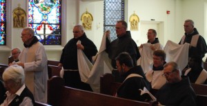 The pall is carried to the casket.