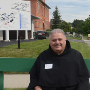 Br. Angelo waits to greet the pilgrims arriving by bus.